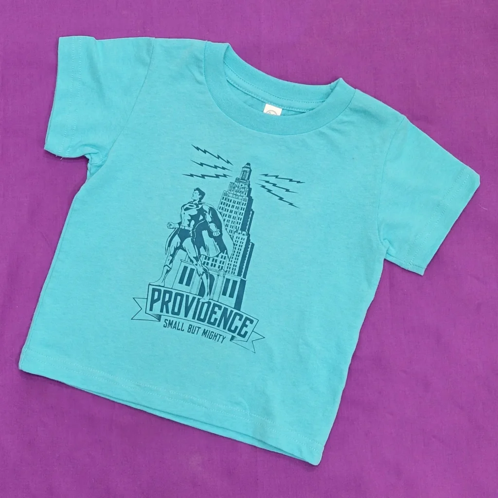 A turquoise t-shirt features a superhero graphic and the text "Providence, Small But Mighty.