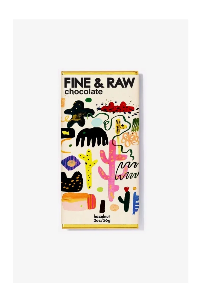 Colorful chocolate bar packaging featuring abstract designs and the text "FINE & RAW chocolate" with hazelnut flavor.