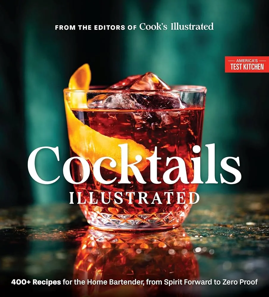 A glass of cocktail with ice and an orange twist, featuring the title "Cocktails Illustrated.