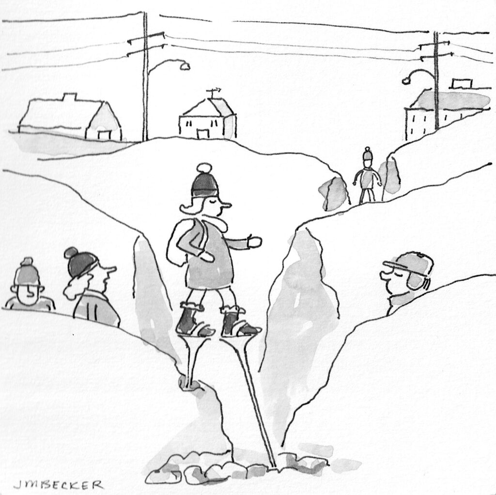 A person on stilts walks across a snowy gap, while others observe from the sides. Houses and power lines are in the background.