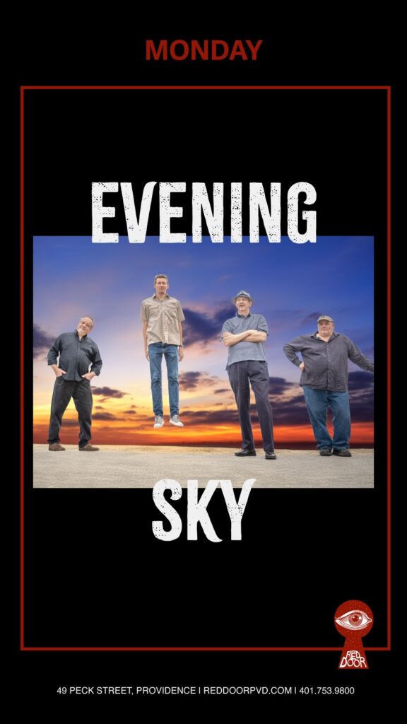 Four men stand against a colorful evening sky, with the word "EVENING" prominently displayed.