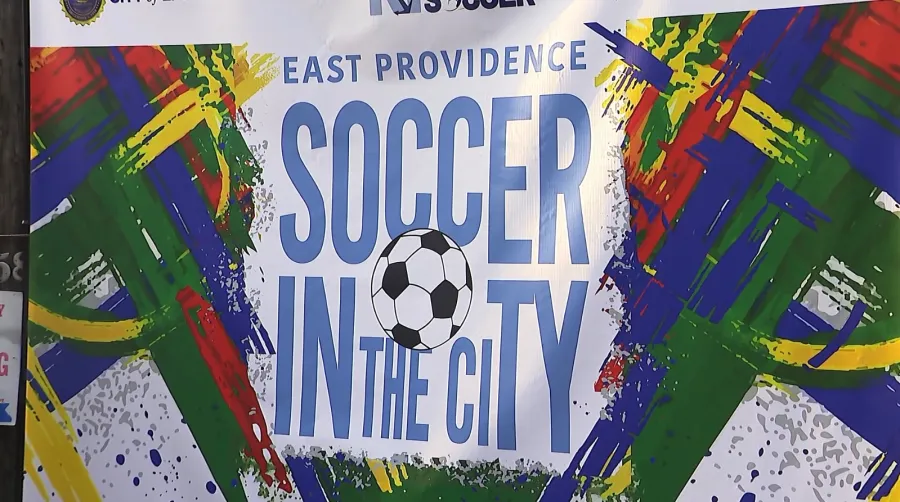 Colorful banner promoting "East Providence Soccer in the City" with a soccer ball graphic.