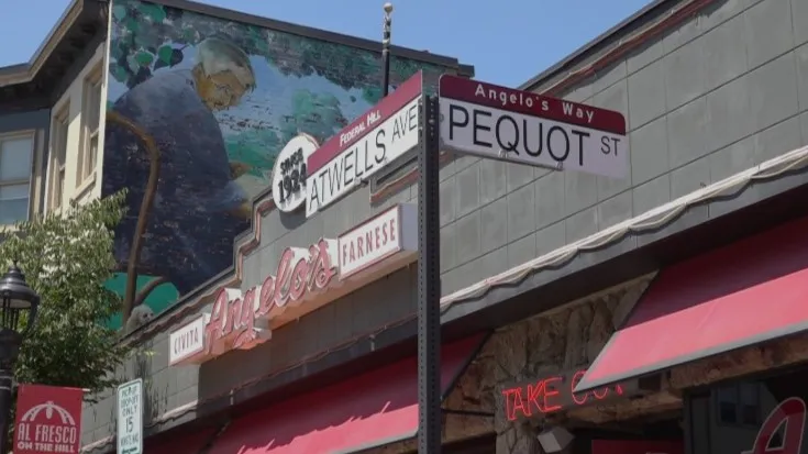 Street signs for Atwells Avenue and Pequot Street, with a mural and Angelo's restaurant visible.