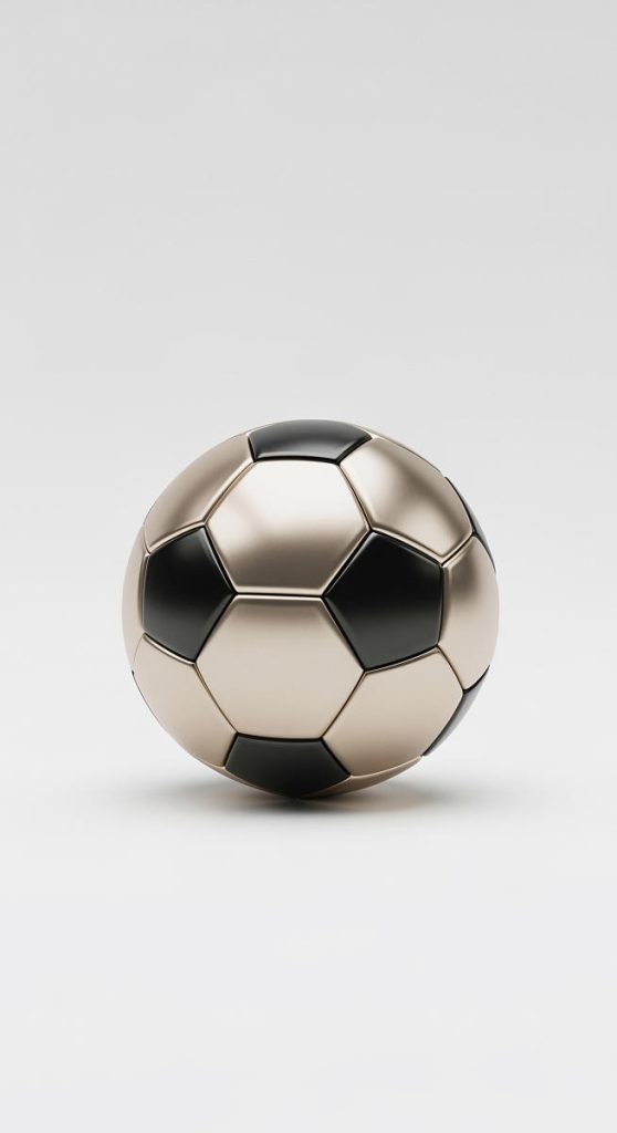 A metallic soccer ball with black and gold panels sits on a white surface.