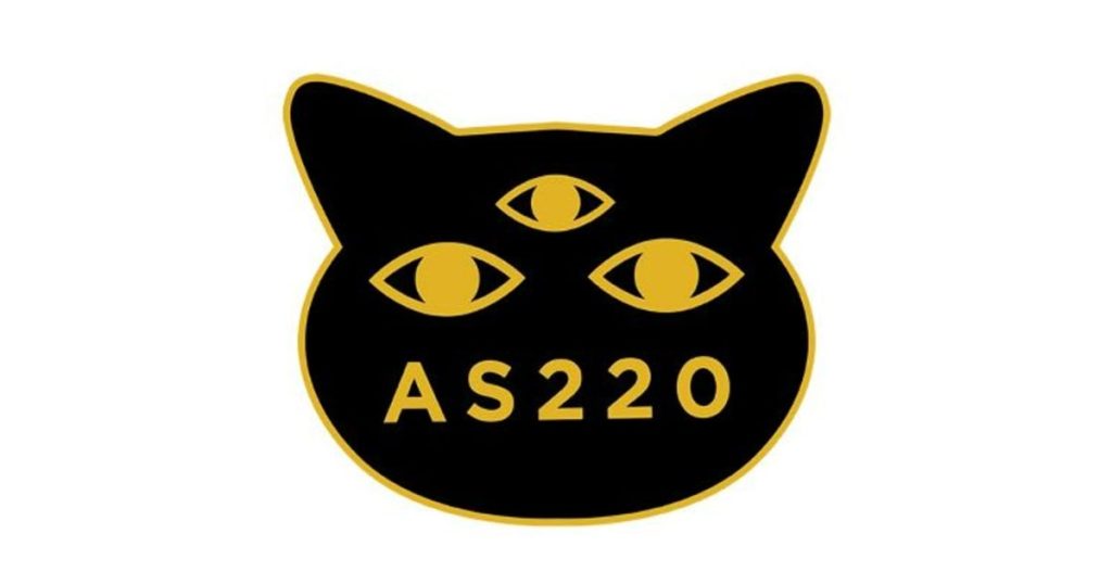 Black cat logo with three eyes and "AS220" in yellow text.