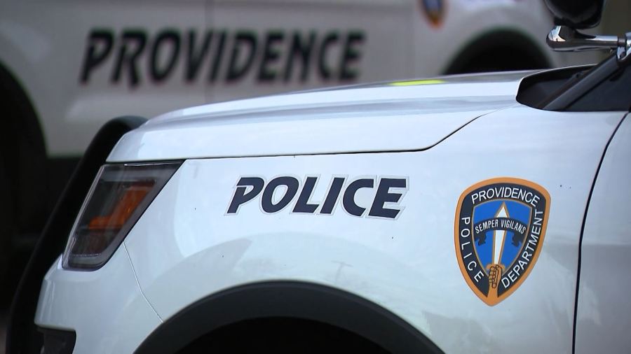 Close-up of a Providence police car, featuring the word "POLICE" and the department's emblem.