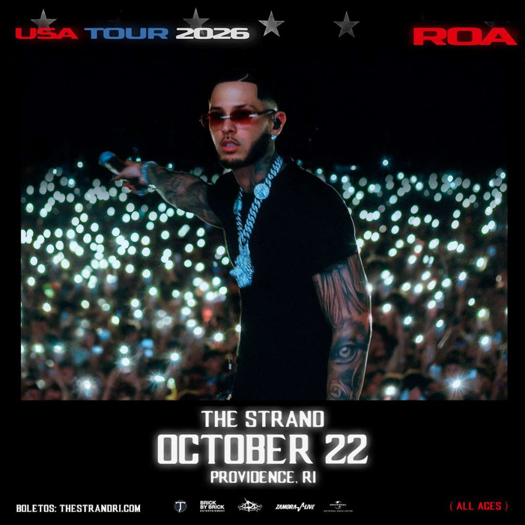 Performer gestures to the crowd, illuminated by numerous phone lights at a concert. Event details are displayed below.