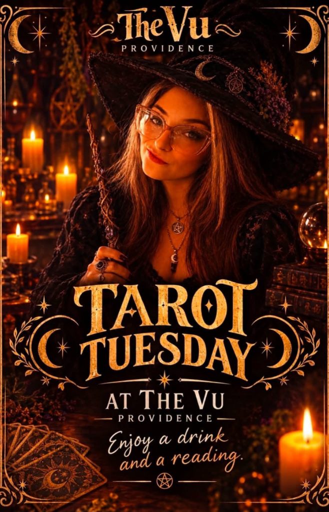 A woman in a witch hat poses with tarot cards and candles, promoting Tarot Tuesday at The Vu in Providence.