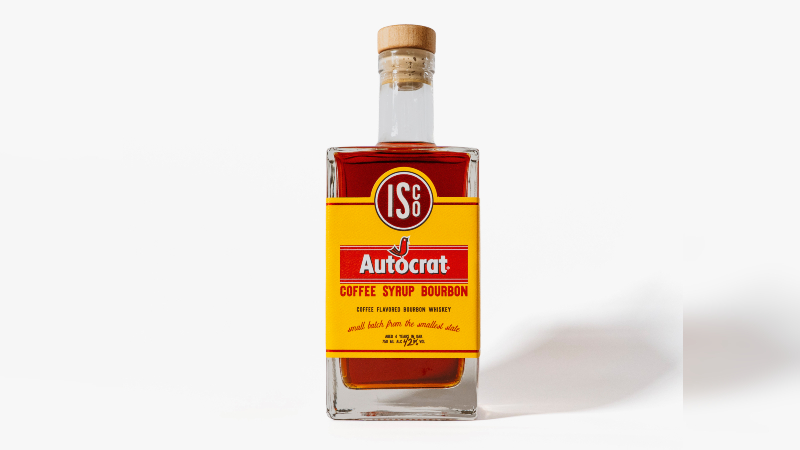 A bottle of Autocrat Coffee Syrup Bourbon with a wooden cork and colorful label.