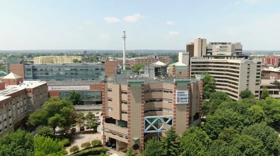 Aerial view of Rhode Island Hospital complex, featuring buildings and surrounding greenery.