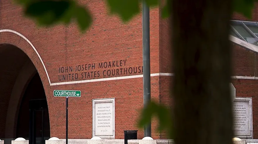Brick facade of John Joseph Moakley United States Courthouse with street sign for Courthouse Way.