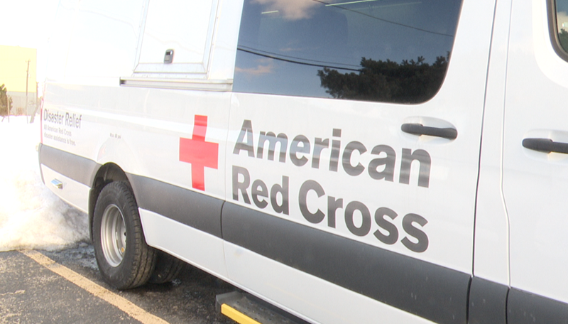 American Red Cross van parked near snow, labeled for disaster relief services.