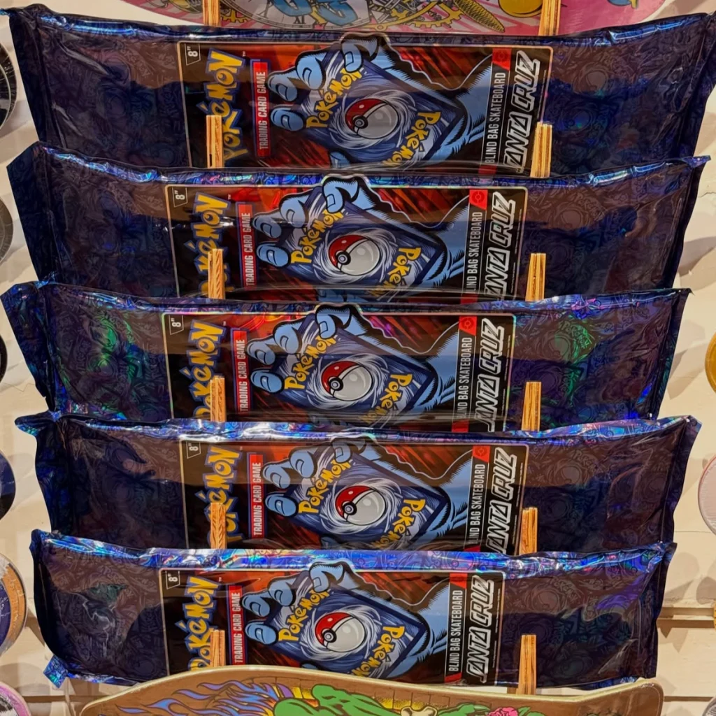 Five stacked Pokémon trading card game packs with colorful designs and branding.
