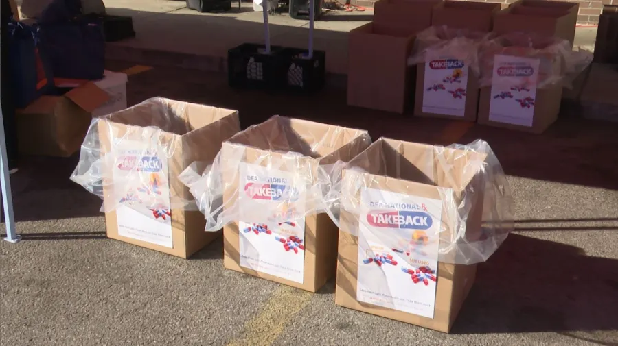 Three empty drug take-back boxes with signs, ready for collection.