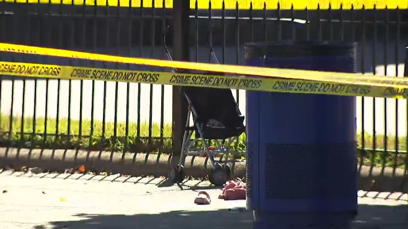 A stroller is positioned near a trash can, surrounded by yellow crime scene tape and scattered shoes.